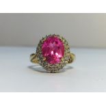 A Pink Sapphire and Diamond Cluster Ring in 9ct yellow gold. Diamonds ETCW 0.44 ct, sapphire ECW 3.