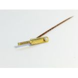 A cased Tie pin fashioned as a cricket bat with 18ct gold head, set with a seed pearl.