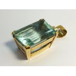 A large rectangular step cut natural Aquamarine pendant.