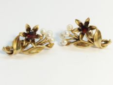 A pair of 1950’s garnet and pearl earrings, fashioned as floral sprays, set in 9ct yellow gold.