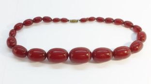 An Art Deco Cherry Amber Necklace, 57.5g.