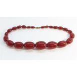 An Art Deco Cherry Amber Necklace, 57.5g.