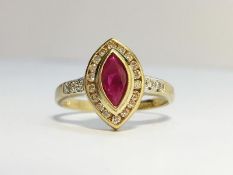 A Ruby and Diamond Ring in 9ct yellow gold. The marquise shape ruby has an ECW of 0.