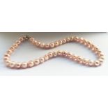 An 18” string of large Peach/Pink toned Cultured Pearls.