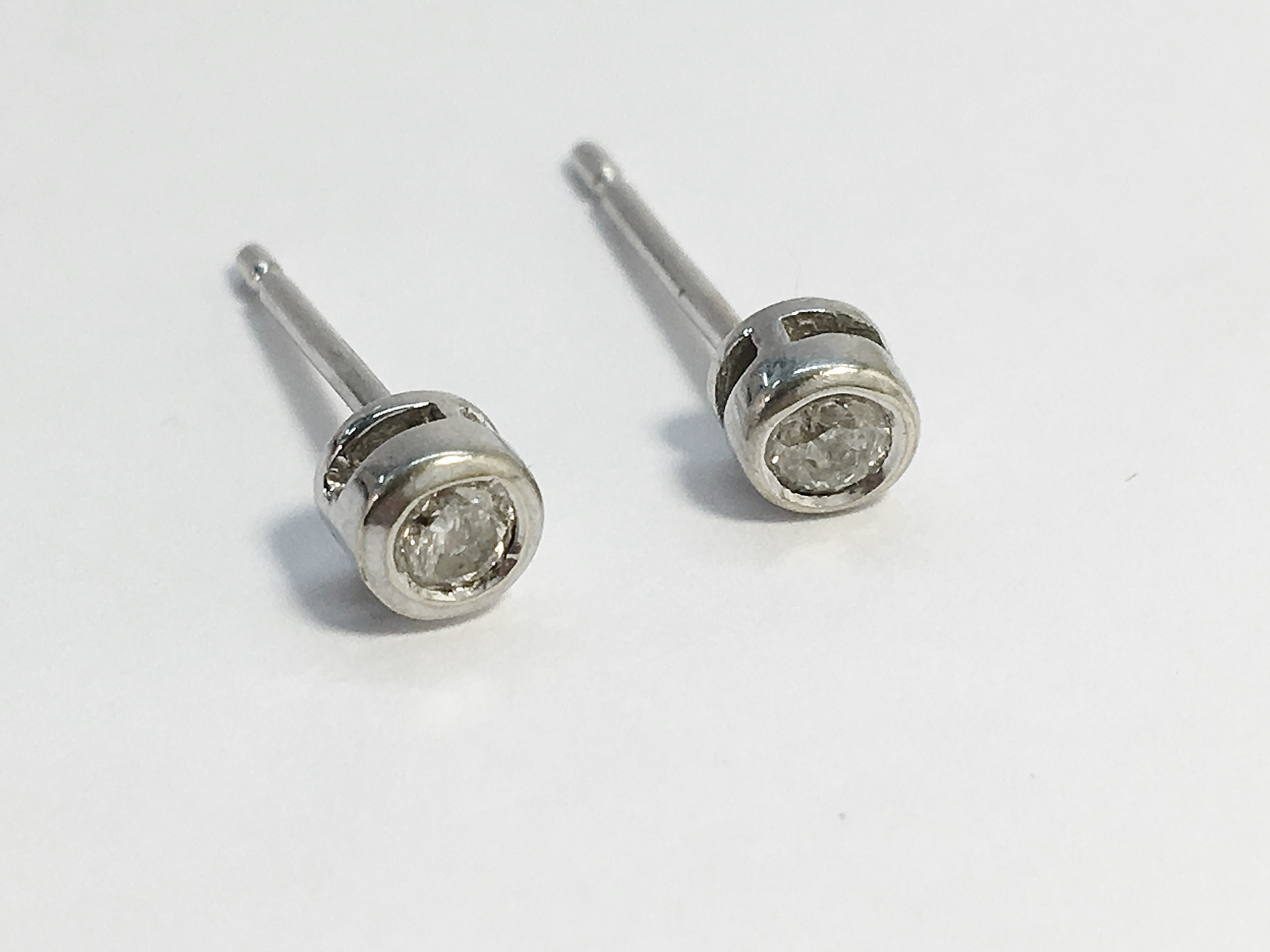 A pair of diamond solitaire earrings in 9ct white gold, the estimated total carat weight is 0. - Image 3 of 3