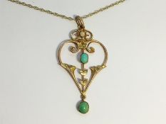 An Art Nouveau Openwork Pendant set in 15ct gold with turquoise.