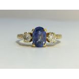 An Oval Ceylon Blue Sapphire ring with brilliant cut diamond shoulders. Sapphire estimated weight 1.