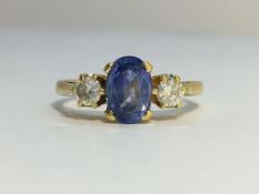 An Oval Ceylon Blue Sapphire ring with brilliant cut diamond shoulders. Sapphire estimated weight 1.