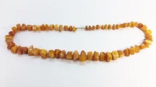 A Butterscotch Amber nugget bead necklace. Approximate length 20” and total weight 59 grams.