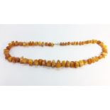 A Butterscotch Amber nugget bead necklace. Approximate length 20” and total weight 59 grams.