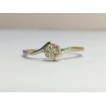 A Diamond Cluster Ring set in 9ct white gold. Diamonds 0.10 ct stamped in band.
