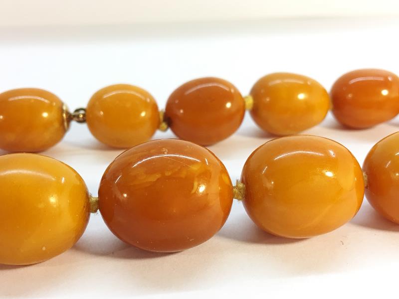 A string of butterscotch amber beads, approximately 18" in length. - Image 2 of 6