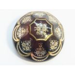 A Victorian tortoiseshell pique work brooch, inlaid with gold and silver.