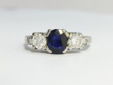 A Sapphire and Diamond Trilogy Three Stone Ring set in 18 carat gold. Oval cut sapphire ECW 0.