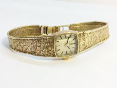 A Ladies 9ct Gold Omega Watch, textured strap. Working order, total weight 19.6 grams.