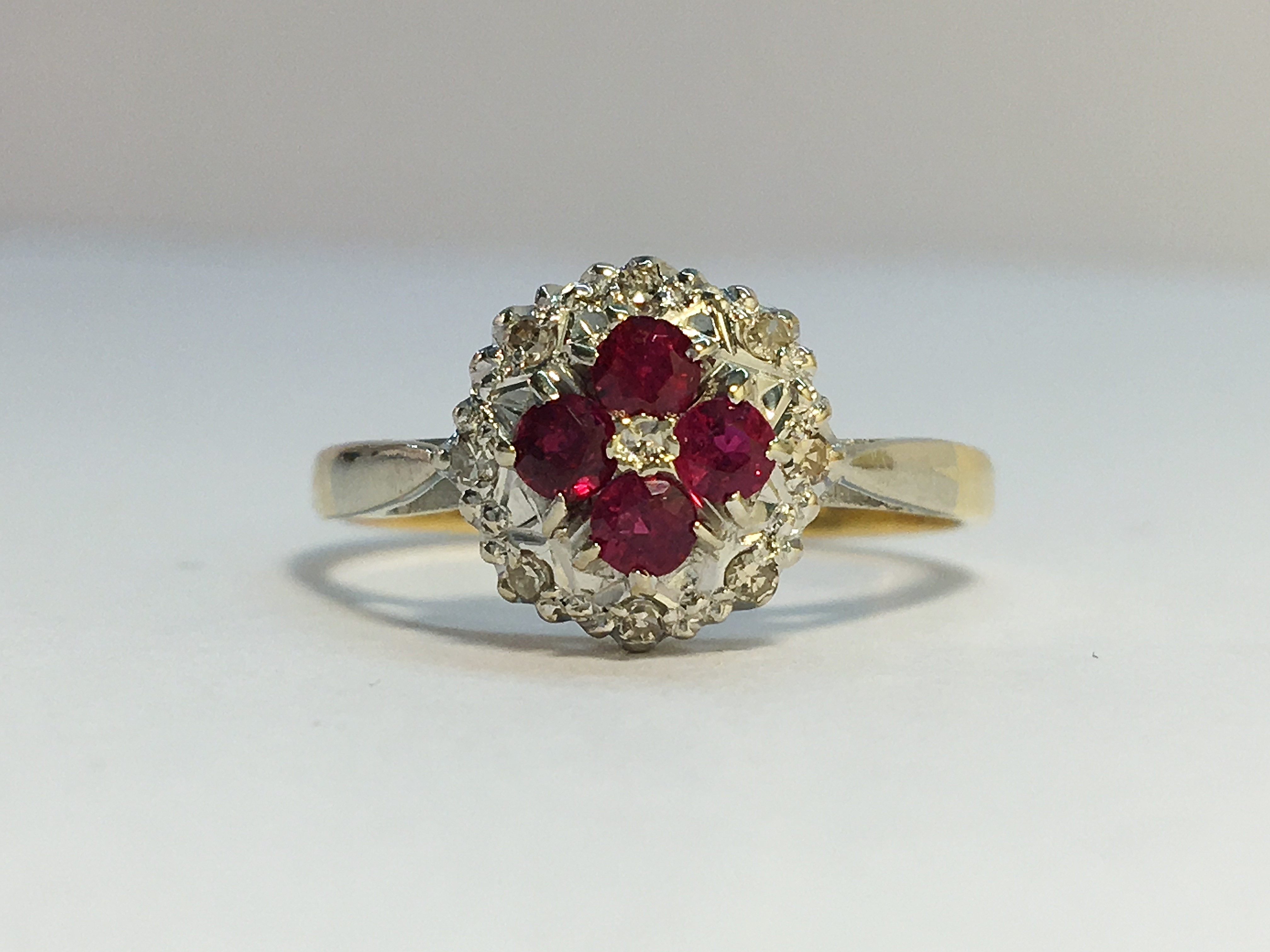 An Ruby and Diamond cluster ring in 18ct yellow and white gold. Rubies ETCW 0.