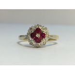 An Ruby and Diamond cluster ring in 18ct yellow and white gold. Rubies ETCW 0.