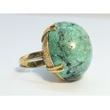 A Vintage 1970s Turquoise Cabochon Egg ring with ornate 18 ct Yellow Gold chased shank.
