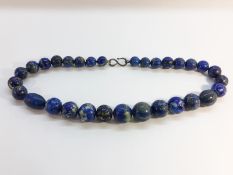 An Antique Lapis Lazuli necklace, of graduated beads from approximately 20mm to 11.5mm in size.