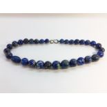 An Antique Lapis Lazuli necklace, of graduated beads from approximately 20mm to 11.5mm in size.