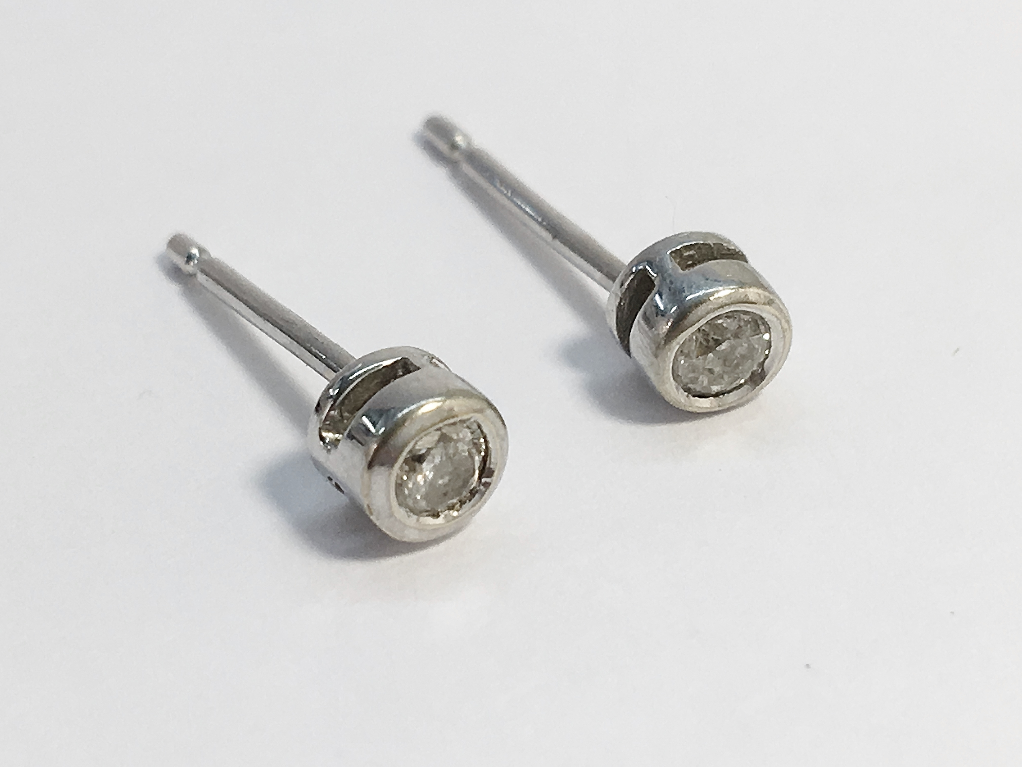 A pair of diamond solitaire earrings in 9ct white gold, the estimated total carat weight is 0.