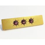 An Edwardian oblong garnet brooch set in 15 carat yellow gold.