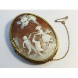 A large Edwardian carved shell cameo in 9ct yellow gold, depicting children playing in a meadow.
