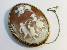 A large Edwardian carved shell cameo in 9ct yellow gold, depicting children playing in a meadow.