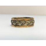 A Celtic Pattern Band Ring in 9ct white and yellow gold. Ring size P. Total weight 2.3 grams.