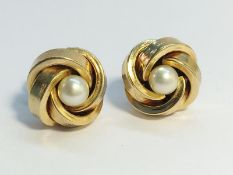 A pair of cultured pearl ear studs set in 9ct yellow gold with ropetwist border.