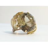 A Smoky Quartz Cocktail ring set in 14 ct gold, fashioned as textured leaves.