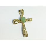 An Openwork cross in 9ct gold, set with a jade cabochon. 26mm high, total weight 1.37 grams.