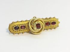 A Victorian Ruby Cannetille Brooch, set in 15ct gold, ETCW 1 ct. Total weight 7.25 grams.