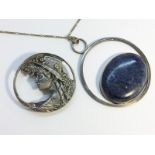 A 1980s silver brooch depicting a young woman, plus a 1970s lapis hoop pendant on silver chain.