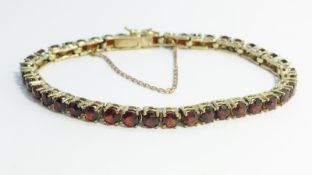 A 1970's garnet bracelet set in 8 carat gold (333 ,German) with trigger clasp,