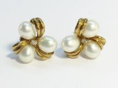 A pair of cultured pearl ear studs set in 9ct yellow gold.