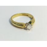 A single stone Diamond ring , six claw set in 18ct yellow gold. The ECW of the diamond is 0.