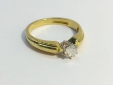 A single stone Diamond ring , six claw set in 18ct yellow gold. The ECW of the diamond is 0.