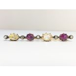 An Antique Diamond, Amethyst and Yellow Sapphire Brooch set in 9ct gold.