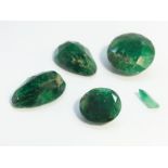 Five loose emeralds, one 8 ct round cut, one 3.1 ct round cut, one 6.7 ct pear shape, one 6.