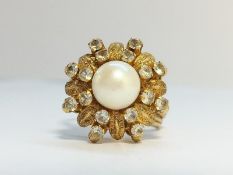 A Cultured pearl ring in 14 ct yellow gold, fashioned as a flower, circa 1970s.