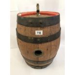 A whisky barrel with red border and tap.