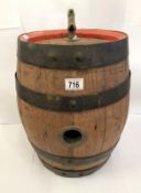 A whisky barrel with red border and tap.