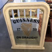 A Guinness advertising mirror in painted frame.