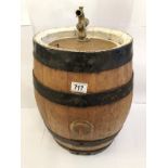 A whisky barrel with white border and tap.