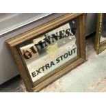 A Guinness Extra Stout advertising mirror.