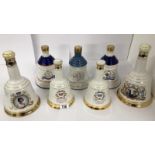 A collection of 7 Royal Commemorative wade whisky bells (sealed and with contents)