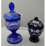 Two blue glass overlaid Jars with lids – 1 cut glass 10.5”h & 1 thumb impressed 7”h (2)