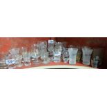 Shelf of bar shot glasses – Carolans, Smirnoff etc & a small box of coloured chemist bottles