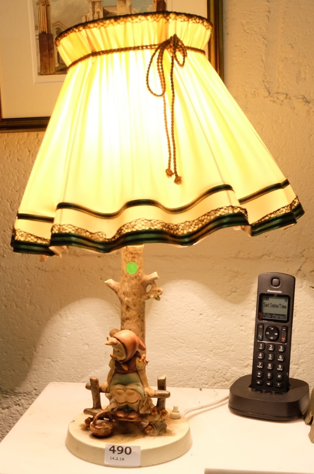 Hummell Table Lamp – figure of a girl seated on a fence, electric with a fluted shade, 16”h